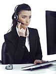 Busy Woman Seriously Hearing The Customer Talk In Headset Stock Photo