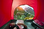 Camping Man Lying In Outdoor Camping Tent With Beautiful Natural Scenic Stock Photo