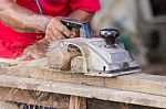 Carpenter Working With Electric Planer Stock Photo
