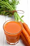 Carrot Juice On White Wood Stock Photo