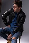 Casual Young Man In Black Leather Jacket And Denim Jeans Stock Photo