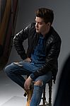 Casual Young Man In Black Leather Jacket And Denim Jeans Stock Photo