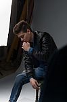 Casual Young Man In Black Leather Jacket And Denim Jeans Stock Photo