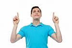 Caucasian Man Point And Looking Upwards Stock Photo