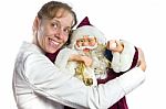 Caucasian Woman Embracing Model Of Santa Claus Stock Photo