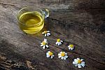 Chamomile Tea And Chamomile Flower On Old Wooden Table Stock Photo