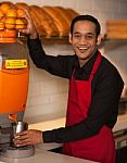 Cheerful Chef Making Fresh Orange Juice Stock Photo