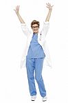 Cheerful Doctor Raising Her Hands Up In Celebration Stock Photo