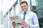 Cheerful Entrepreneur Reading Newspaper Stock Photo
