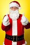 Cheerful Male In Santa Costume Showing Double Thumbs Up Stock Photo
