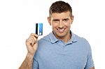Cheerful Man Holding Credit Card Stock Photo