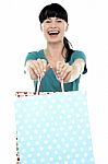 Cheerful Woman Holding Polka Dot Shopping Bags Stock Photo