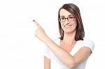 Cheerful Woman Pointing To Her Right Stock Photo