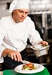 Chef Arranging Tossed Salad In A Bowl Stock Photo