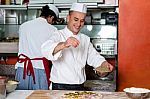 Chef Busy In Process Of Preparing Pizza Stock Photo