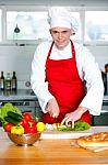 Chef Chopping Vegetables In Kitchen Stock Photo