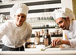 Chef Watching His Assistant Arranging Dish Stock Photo