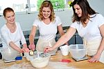 Chefs Collecting Flour From Bowl Stock Photo