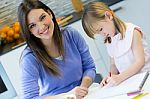 Child Drawing With Crayons With Her Mom At Home Stock Photo