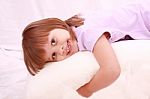 Child Lying On Bed Stock Photo