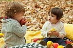 Children Play In The Park And Eating Apple Stock Photo