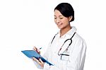 Chinese Doctor Standing With Folder Stock Photo