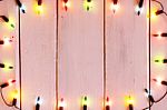 Christmas Light Decorations On Wood Texture Stock Photo