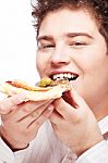 Chubby Boy Eating A Slice Of Pizza Stock Photo