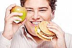 Chubby Man Holding Apple And Hamburger Stock Photo