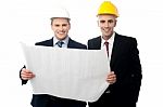Civil Engineers Reviewing Construction Plan Stock Photo