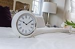 Classic White Alarm Clock Style In Classic Bedroom Stock Photo