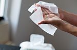 Clean Hands With Wet Wipes, Blurred Package In Background Stock Photo