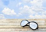 Clear Sky In Eyeglasses On The Wooden Background Stock Photo