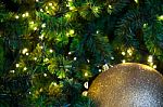 Close Up Big Yellow Glitter Ball Christmas On Tree With Wire White Light Background Stock Photo