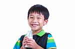 Close Up Boy Smiling And Holding Bottle Of Milk, On White Stock Photo