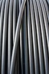 Close-up Of Black Electricity Cable Verticla On A Spool Stock Photo