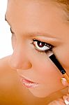 Close Up Of Female Putting Eye Liner Stock Photo