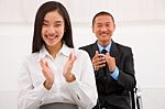 Close-up Of Smiling Businesspeople Clapping Stock Photo