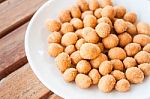 Close Up Of Spicy Peanuts Snack On White Dish Stock Photo