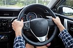 Close-up Of Woman's Hand Holding Steering Wheel For Car Driver Stock Photo