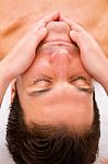 Close-up Of Young Man Getting Face Massage Stock Photo