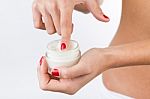 Close Up Portrait Of Woman Applying Cream On Hands Stock Photo