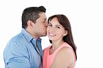 Close-up Portrait Of Woman Being Affectionately Kissed By Her Hu Stock Photo