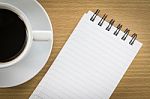 Coffee And Notepad On Wood Table Stock Photo