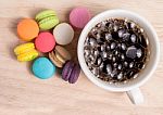 Coffee Cup With Colorful Macarons Stock Photo