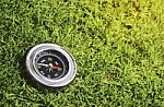 Compass On Green Grass Stock Photo