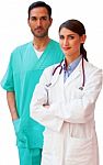 Confident Female Doctor Standing With Male Nurse Stock Photo