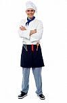 Confident Young Cook Posing In Uniform Stock Photo