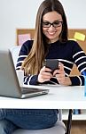 Confident Young Woman Working In Her Office With Mobile Phone Stock Photo