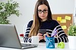 Confident Young Woman Working In Her Office With Mobile Phone Stock Photo